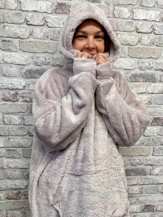 Unisex Blanket Hoodie with hood and front pocket, soft polyester fabric.