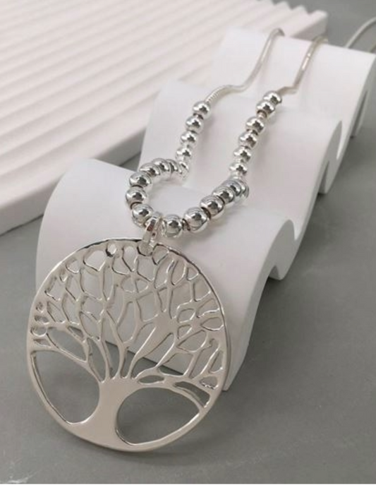 Tree of Life Necklace on display stand.