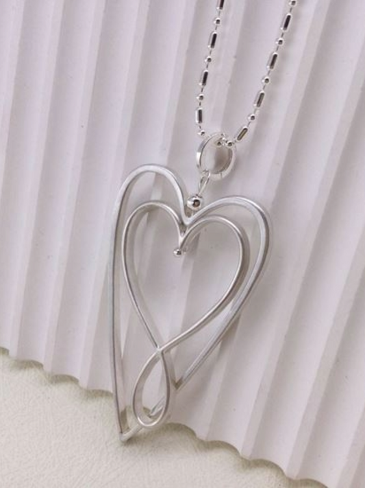 Double Heart Necklace on a display stand.