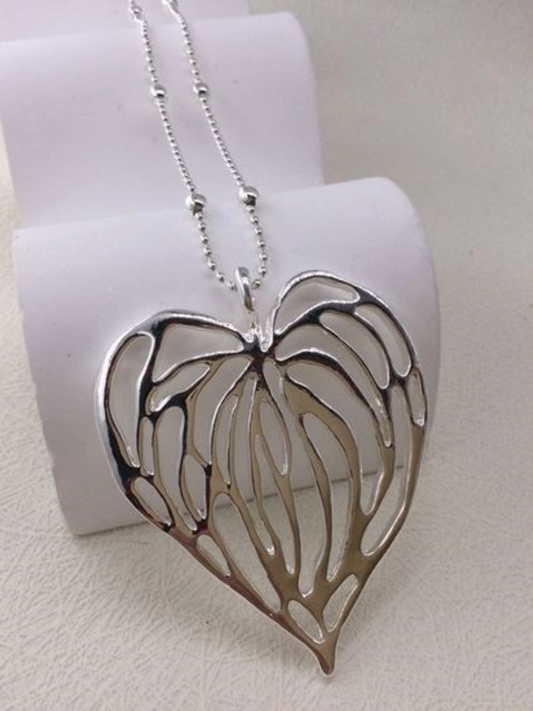 Heart Necklace with Lattice Design on a display stand.