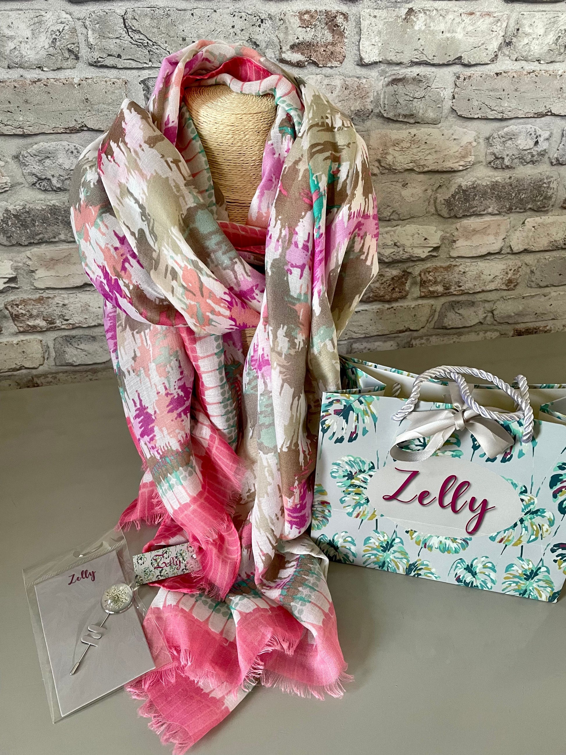 Zelly Scarf in vibrant colors displayed with packaging.